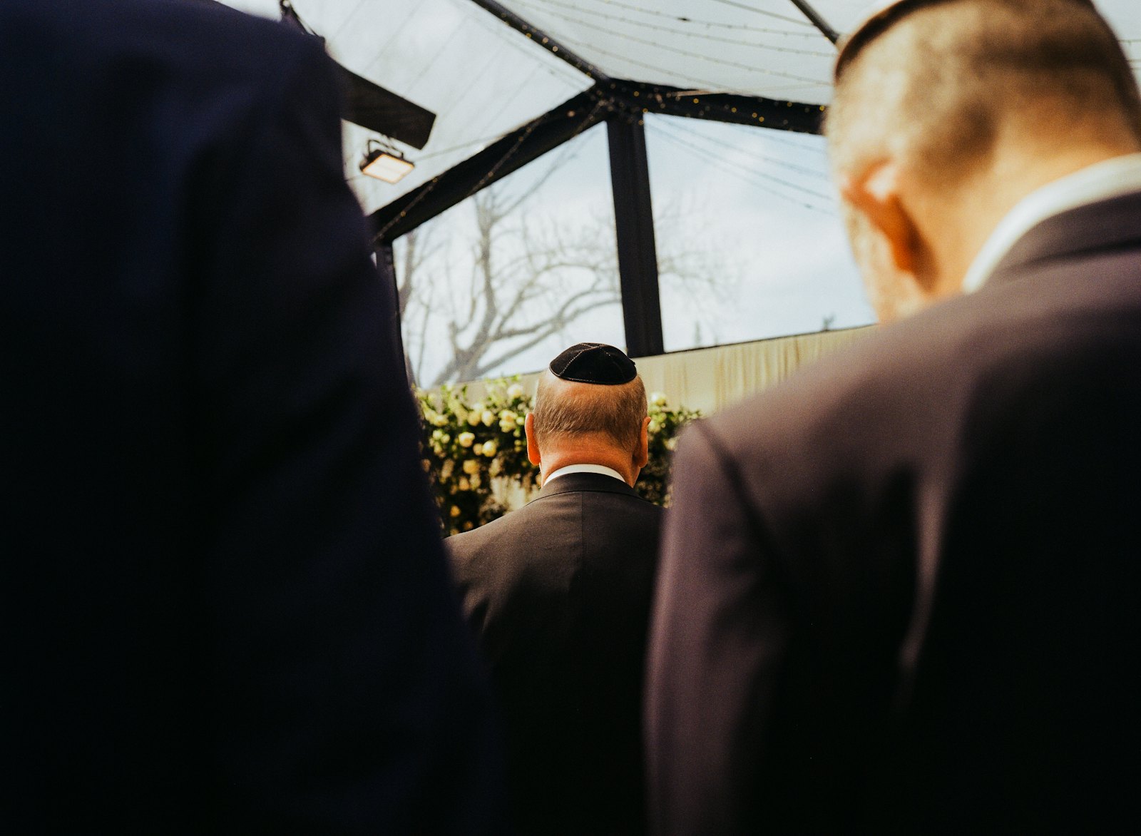 Guests in kippot seated at a wedding ceremony